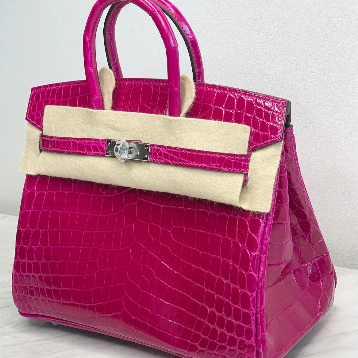 Fashionphile - Looking for something REALLY special? We have a Hermes Shiny  Niloticus Crocodile Birkin 25 in Rose Scheherazade. It's crafted of shiny  exotic niloticus crocodile leather in bright pink, perfect for
